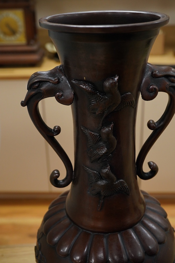 A large pair of Japanese bronze vases, early 20th century, decorated in relief with birds and flowers, 45cm high